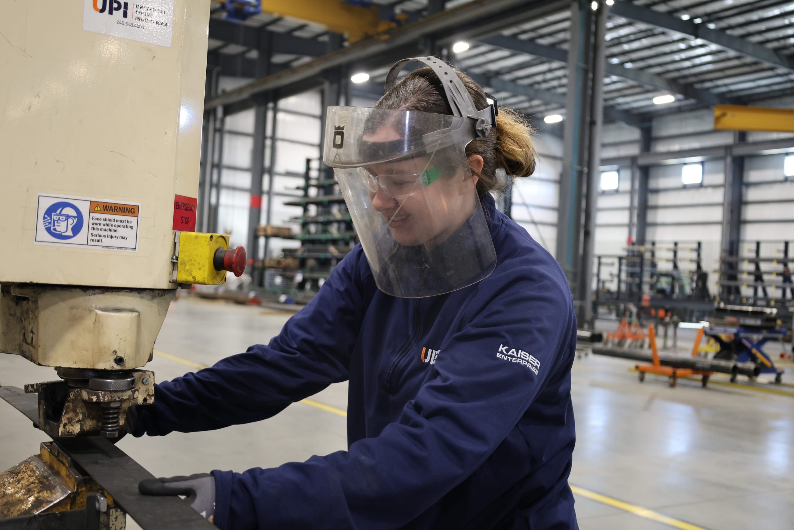 UPI team member operating fabrication equipment