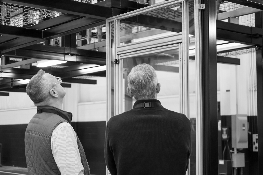 UPI team members reviewing mechanical infrastructure in the fabrication facility.