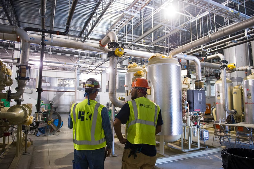 UPI team members reviewing mechanical systems in an industrial facility