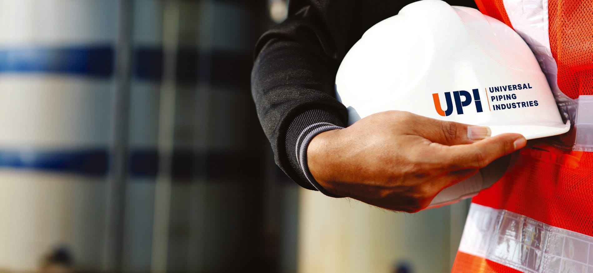 UPI employee holding a safety helmet